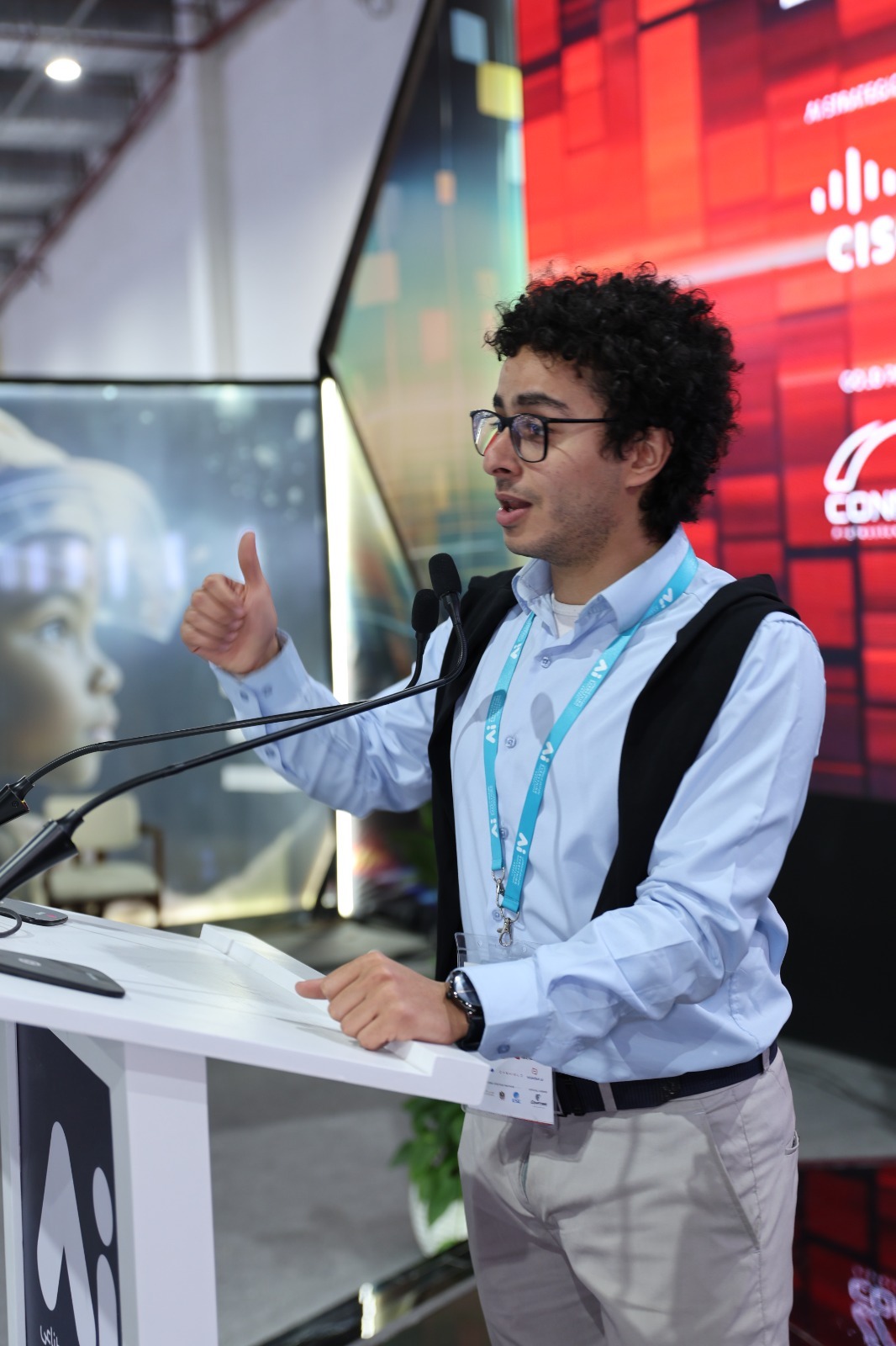 Yassin speaking on stage